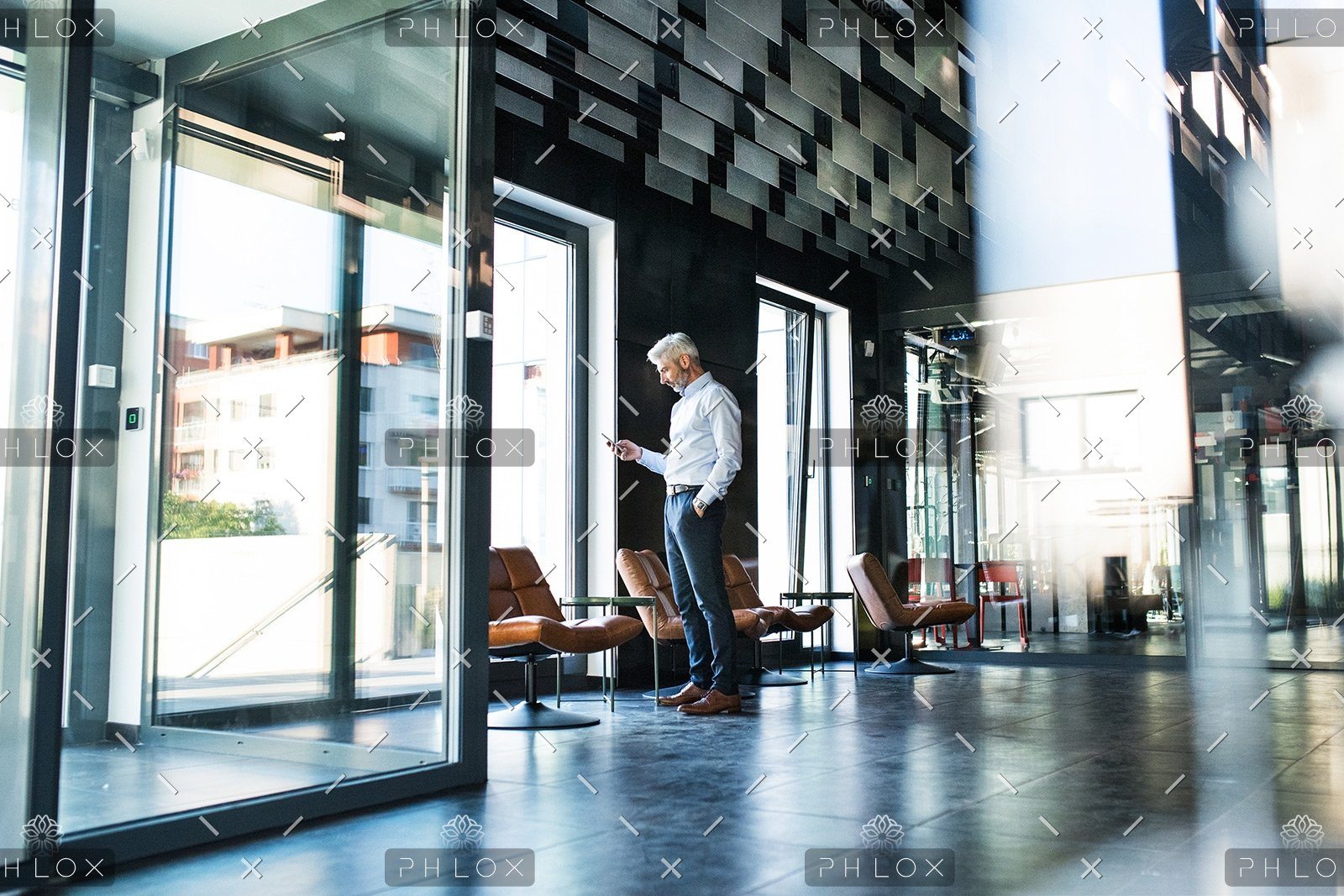 demo-attachment-30-Mature-businessman-with-smartphone-in-the-office.